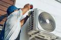 repairman working on maintenance outside unit air source heat pump