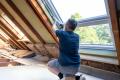 professional installer working on home insulation
