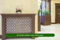 Wooden radiator cover in a cozy living room showing how it affects heat output and room warmth
