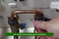 Person refilling a central heating system using a combi boiler pressure valve