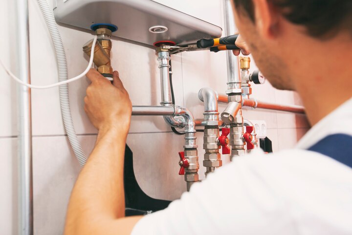 plumber screwing nut pipe heating system gas boiler