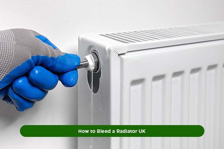 Person using a radiator key to bleed a radiator in a UK home